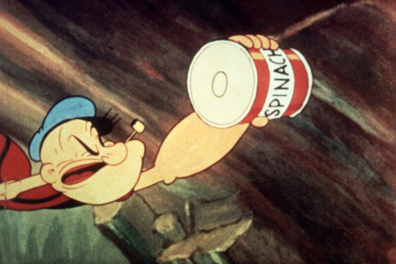 Popeye reaches for a can of spinach in a still from an unidentified <em>Popeye</em> film, c. 1945. Scientists at American University believe the leafy green has the potential to help power future fuel cells.
