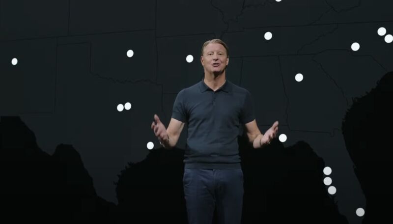 Verizon CEO Hans Vestberg speaking on stage in front of a coverage map.