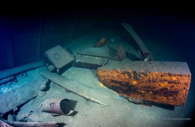 Color photo of shipwreck and cargo underwater