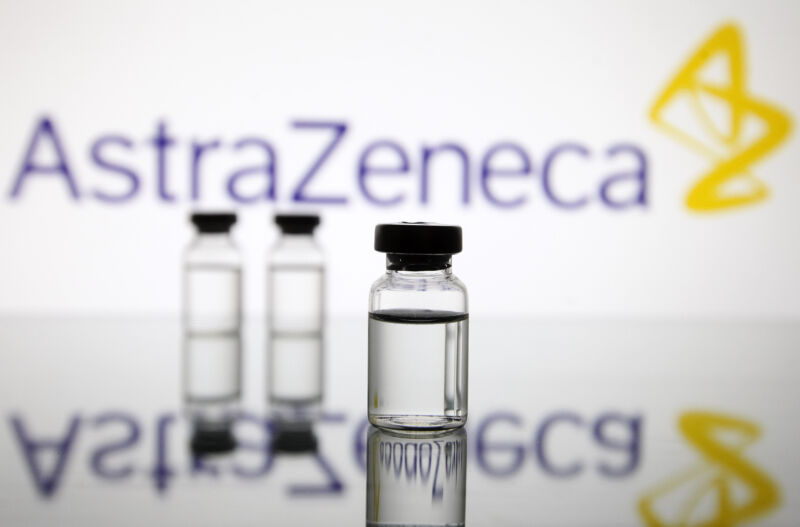 Vials in front of the AstraZeneca British biopharmaceutical company logo are seen in this creative photo taken on 18 November 2020.