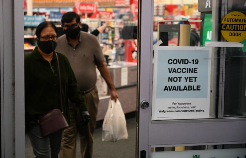 A sign on the entrance to a pharmacy reads "Covid-19 Vaccine Not Yet Available", November 23, 2020 in Burbank, California. 