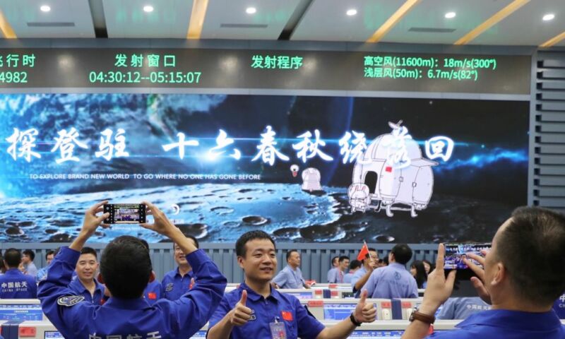 Technicians celebrate the successful launch of the Chang'e-5 spacecraft at the Wenchang Spacecraft Launch Site in south China.