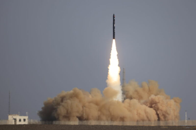 A rocket leaves a trail of flame and smoke as it lifts off.