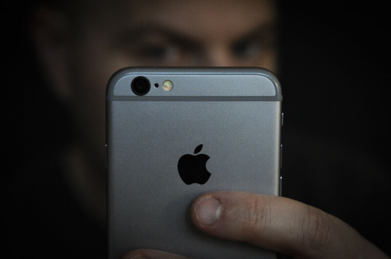 A man glowers at an iPhone, just as ad firms are worried iOS users will when they discover how they are being tracked and that they can opt out of it.