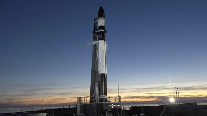 An Electron rocket stands on the launch pad in New Zealand, ready to go.