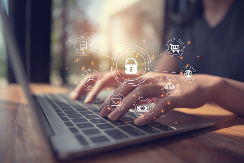 Digital Composite Image Of Businessman Using Laptop With Icons At Desk