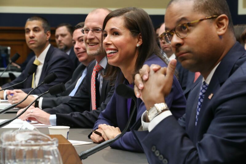 All five FCC commissioners sitting at a table in front of microphones at a congressional hearing.