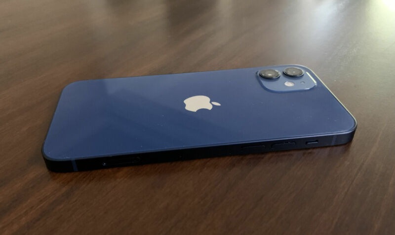 A blue smartphone sits face down on a table.