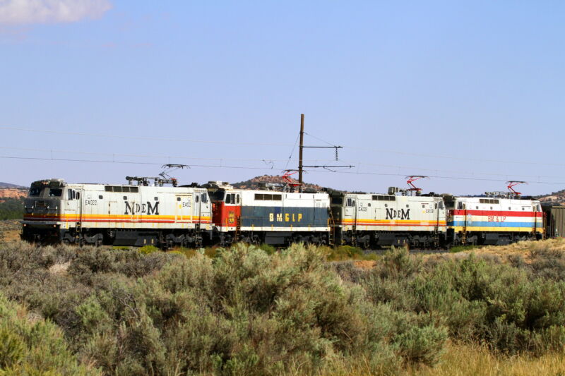 A train cuts across the scrubby Southwest.