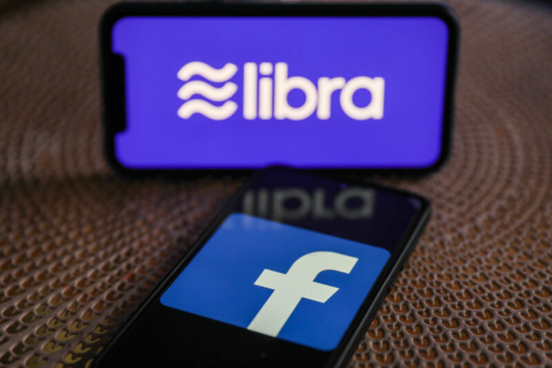 Two cell phones next to each, one with Libra logo and the other with Facebook logo.