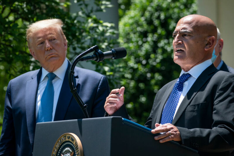 President Donald Trump listens as Moncef Slaoui, the former head of GlaxoSmithKlines vaccines division, speaks about coronavirus vaccine development in the Rose Garden of the White House on May 15, 2020 in Washington, DC. 