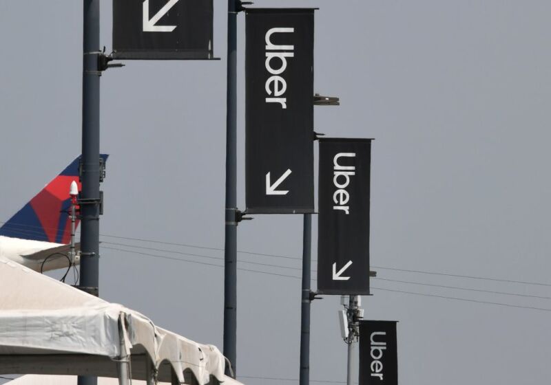 Uber signs are seen August 20, 2020 at Los Angeles International Airport in Los Angeles, California. - Rideshare service rivals Uber and Lyft were given a temporary reprieve on August 20 from having to reclassify drivers as employees in their home state of California by August 21. (Photo by Robyn Beck / AFP) (Photo by ROBYN BECK/AFP via Getty Images)