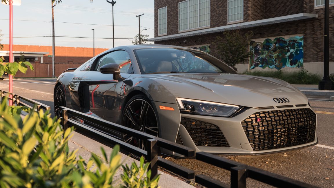 An Audi R8 parked by some railings