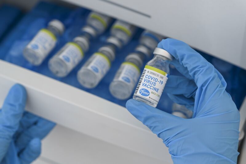 Vials with COVID-19 Vaccine labels showing the logos of pharmaceutical company Pfizer and German biotechnology company BioNTech.