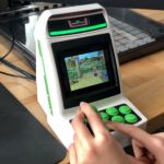 Ars Technica's Aurich Lawson shows how well the ACM's small controls scale to grown-up hands while playing Golden Axe: Revenge of Death Adder. Lawson has opted not to turn on the