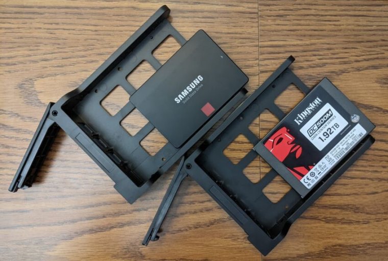 Computer components sit on a woodgrain desk.