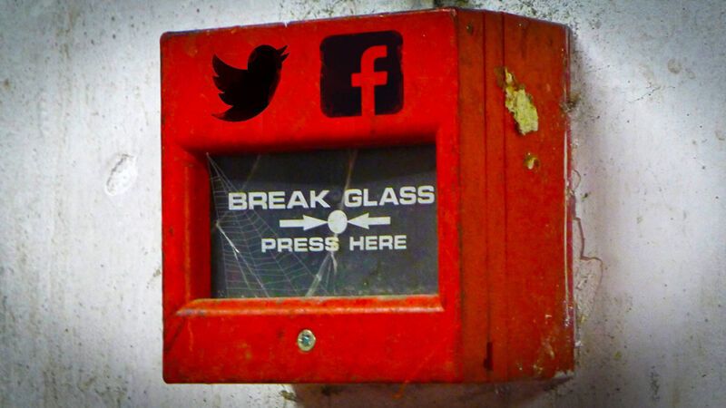 Logos for Twitter and Facebook are photoshopped onto a hand-operated fire alarm.