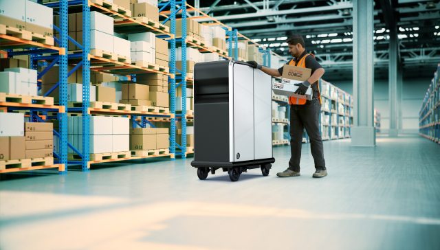 A man pushes a pallet inside a warehouse