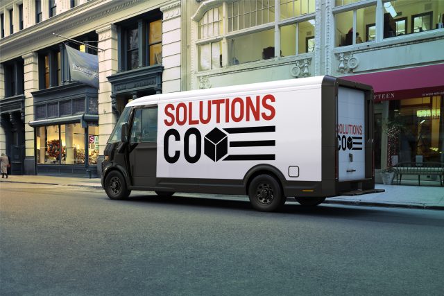 An electric van parked in the street.