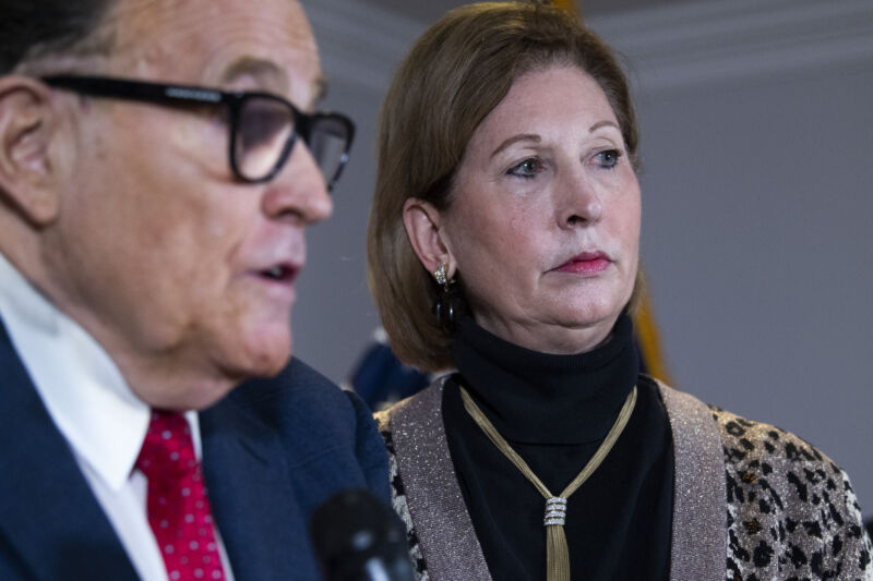 Sidney Powell, flanked by Rudy Giuliani, at a press conference on Nov. 19, three days before the Trump campaign publicly cut ties with her.