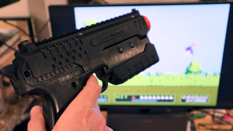 Close-up photo of hand with plastic rifle,