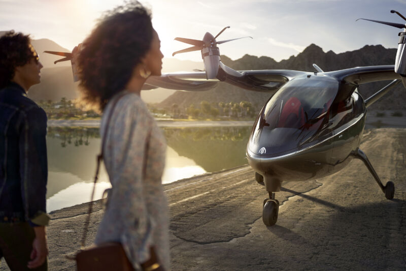 Passengers head toward a tiny aircraft that isn't quite a helicopter or a propellor plane.