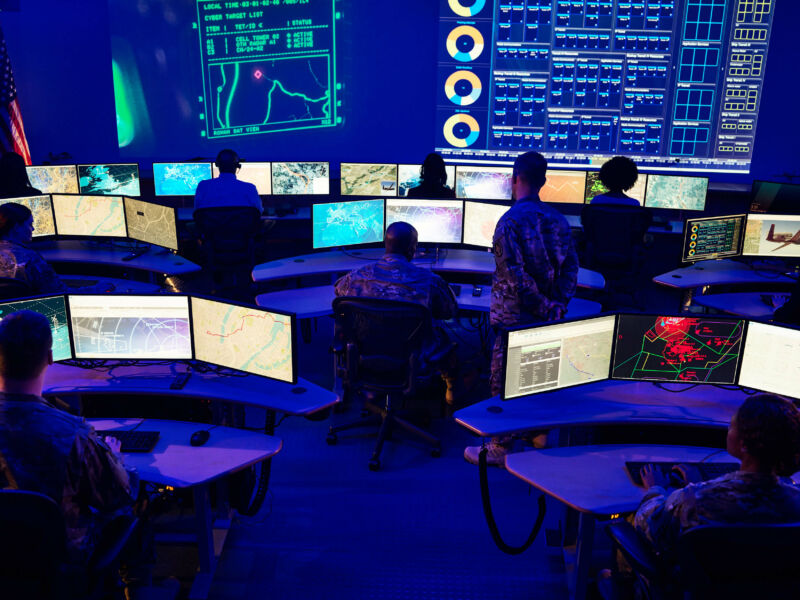 Fancy desks and cool blue lighting dominate this control room at Northrop Grumman's Colshire location.