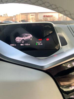 A VW ID.4 main instrument display showing charging time remaining