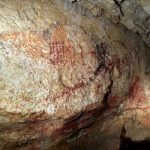 This is one of the many painted panels on the walls of Marsoulas Cave, decorated with red ocher pigment in a style similar to the dotted pattern on the conch shell.
