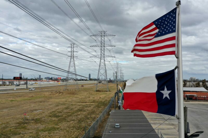 Us And Texas Flags Seen Next To Power Lines And Transmission Towers.