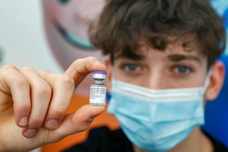 Jonathan, a 16-year-old teenager, receives a dose of the Pfizer-BioNtech COVID-19 coronavirus vaccine at Clalit Health Services, in Israel's Mediterranean coastal city of Tel Aviv on January 23, 2021. 