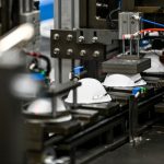 Medical masks move along a conveyor belt.
