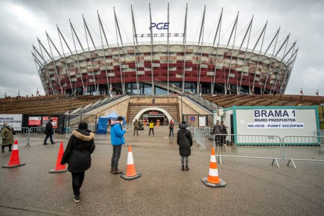 Visitors at an entrance to a COVID-19 vaccination center at the Polish National Stadium in Warszawa, Poland.