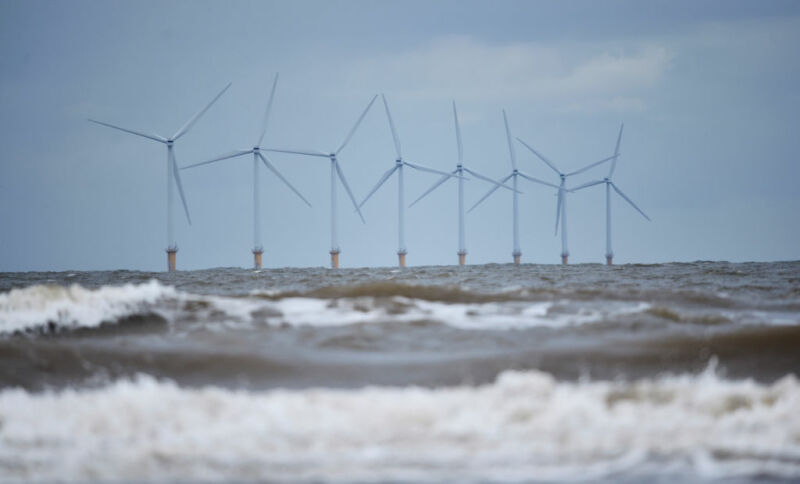 Moderate seas surround an offshore wind farm.