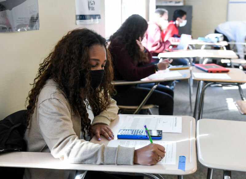 Image Of Mask-Wearing Students In A Classroom.