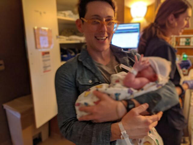 Before mid-March 2020 in a delivery room: no masks in sight, but I spy a delirious dad with ill-fitting glasses.
