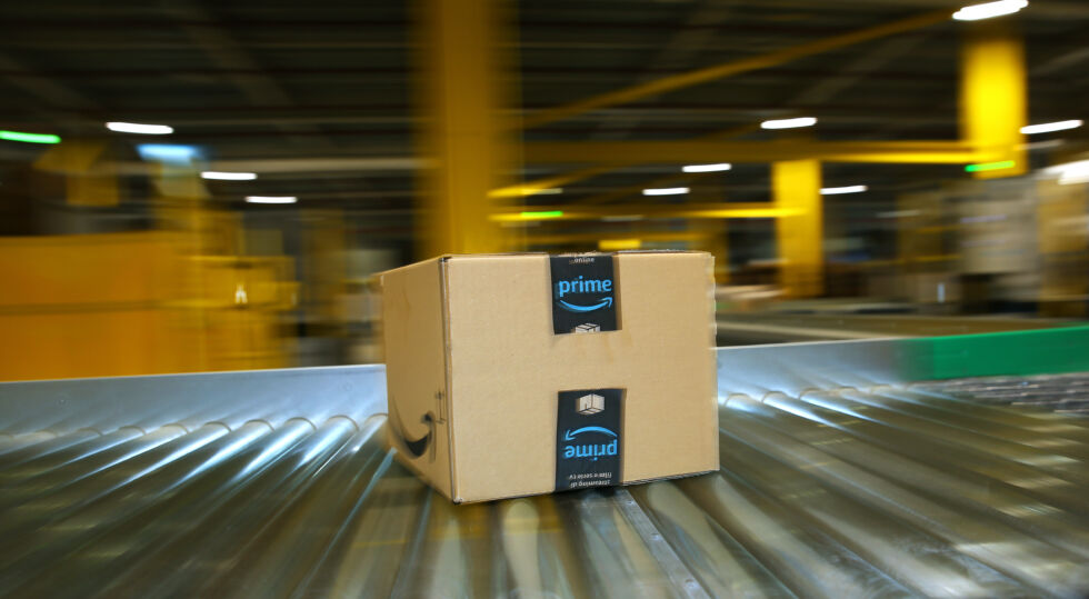 A package is transported on a conveyor belt in an Amazon logistics center.