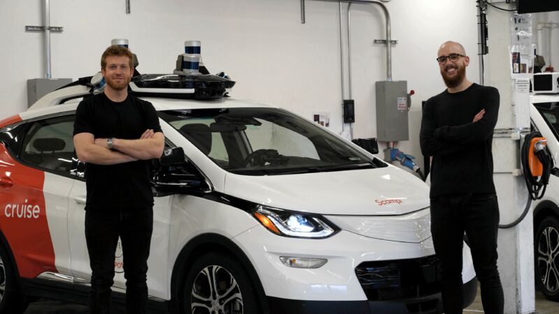 Technology Promotional image of two men standing next to an electric car.