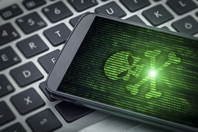 Technology Stock photo of skull and crossbones on a smartphone screen.