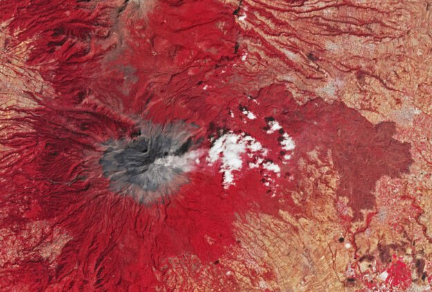 Popocatépetl, a volcano near Mexico City, steams away in this false-color satellite image (making vegetation appear red).