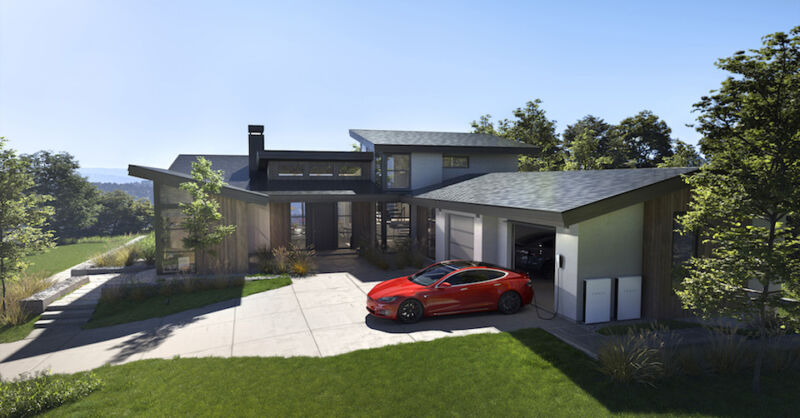 An upscale suburban house has a Tesla in the driveway and solar panels on the roof.