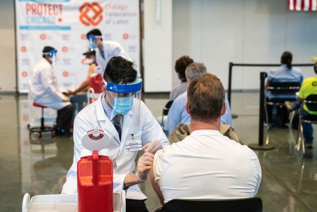 An unidentified man gets a Johnson &amp; Johnson COVID-19 vaccine ahead of Vice President Kamala Harris touring a COVID-19 vaccination site in Chicago earlier this month.