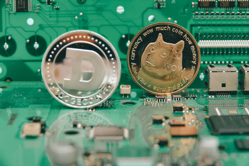 Physical representations of virtual dogecoins sit atop computer components.