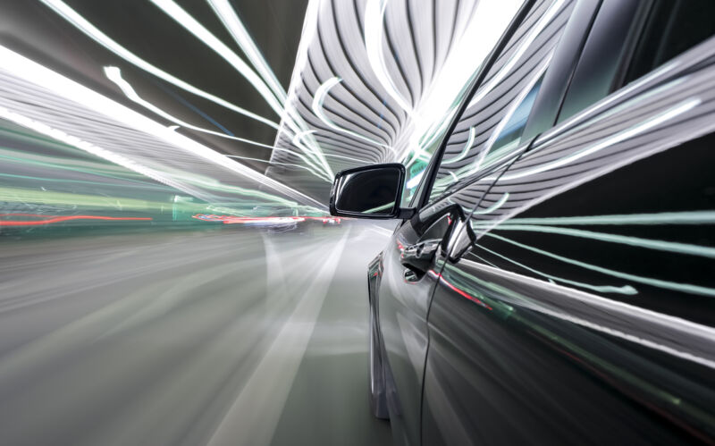 black German car drives through a modern tunnel