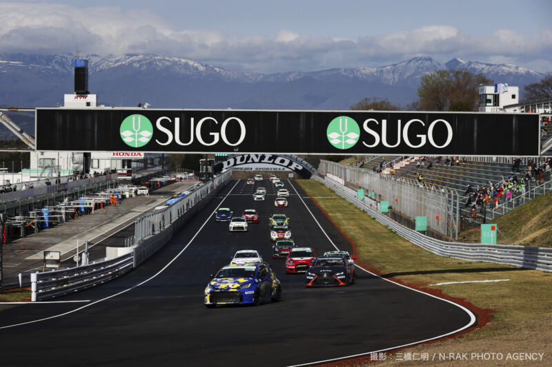 A grid of racing cars at a track in Japan