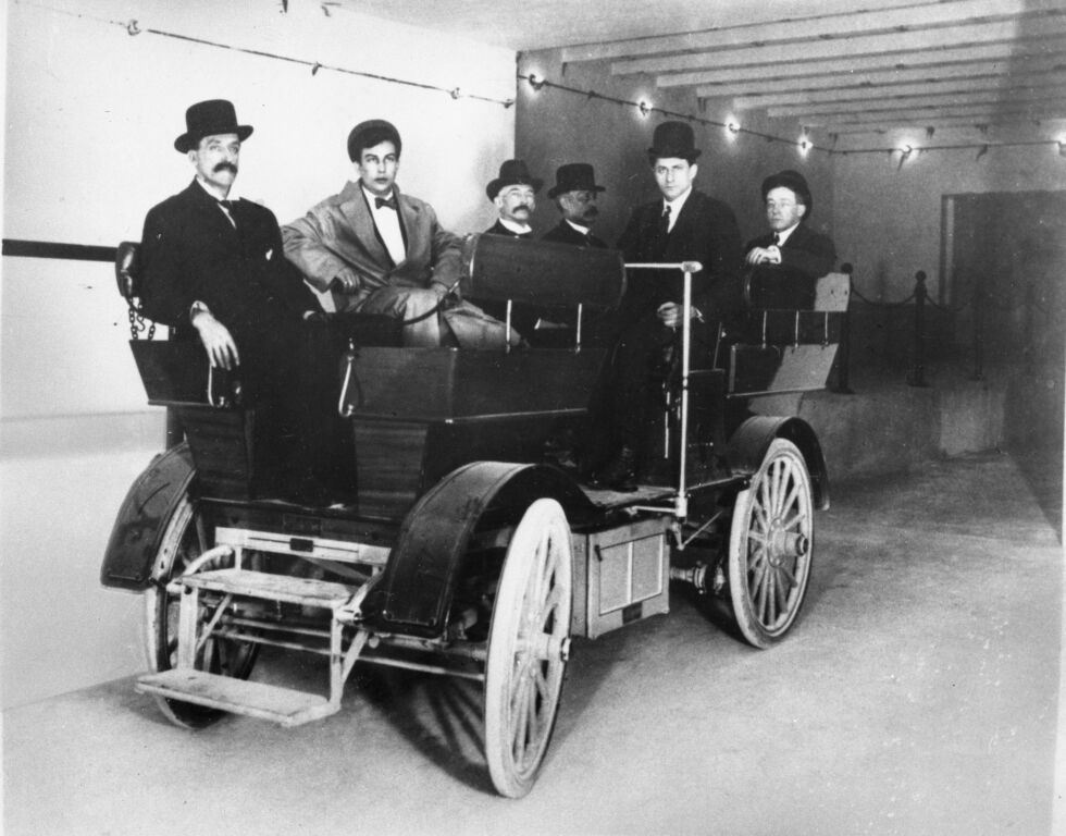 A group of unidentified US senators and staff members as they sit in an electric Studebaker car in the tunnel that links the Russell Senate Office Building to the United States Capitol, Washington, DC, 1909. 