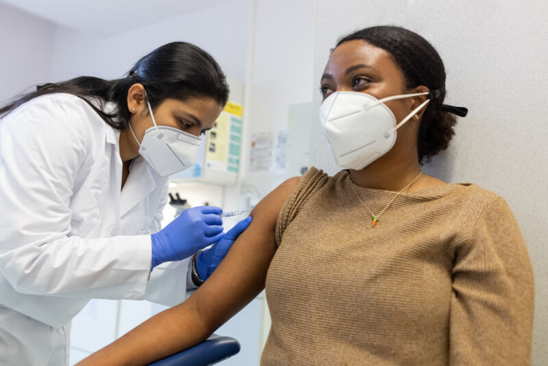 Image of a woman receiving a vaccine.