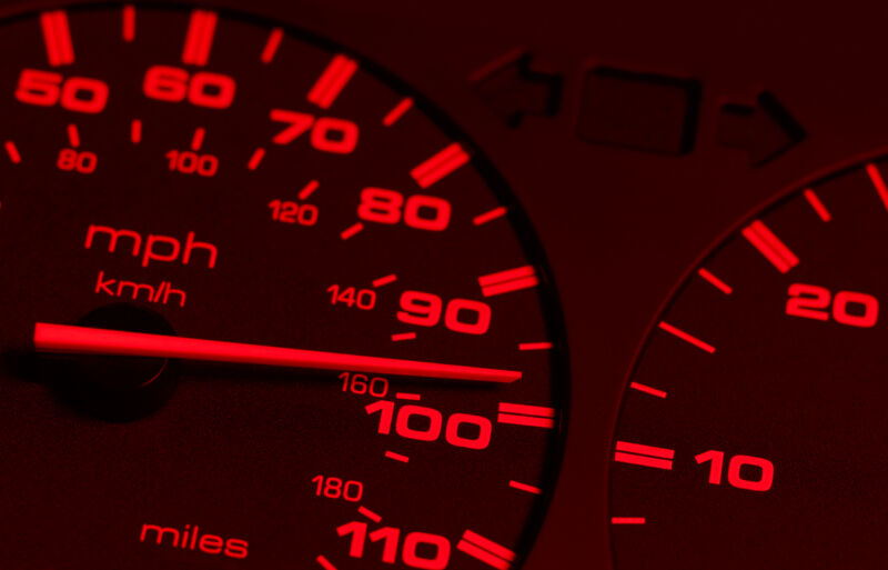 Stock photo of extreme close-up of redline speedometer.