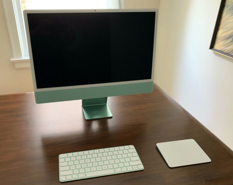 An iMac with keyboard and trackpad