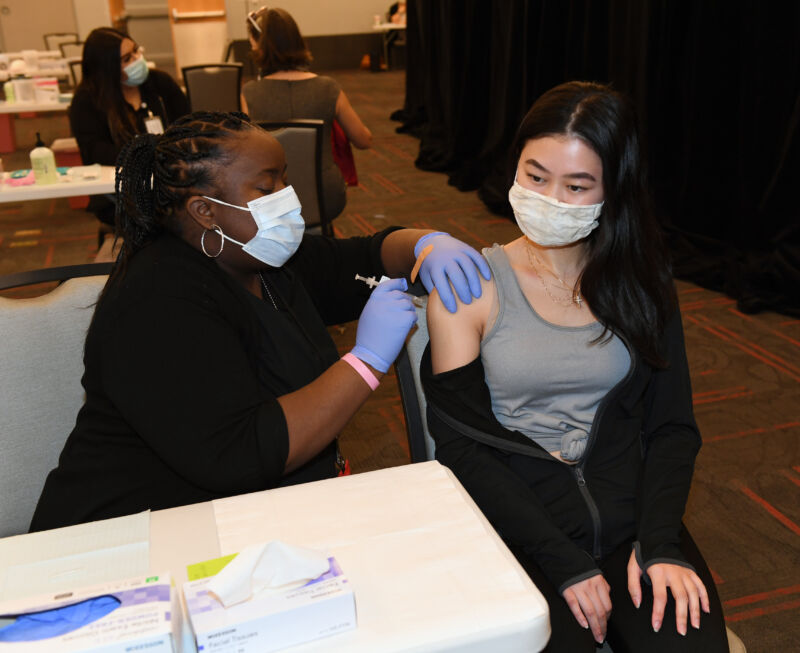 A UNLV Medicine medical assistant administers a Pfizer-BioNTech COVID-19 vaccination to a UNLV School of Nursing student.